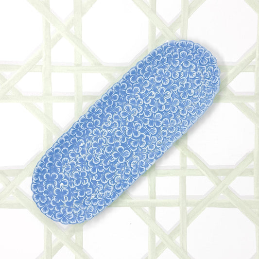 A rectangular blue porcelain appetizer platter featuring an embossed hydrangea floral design, displayed against a white background
